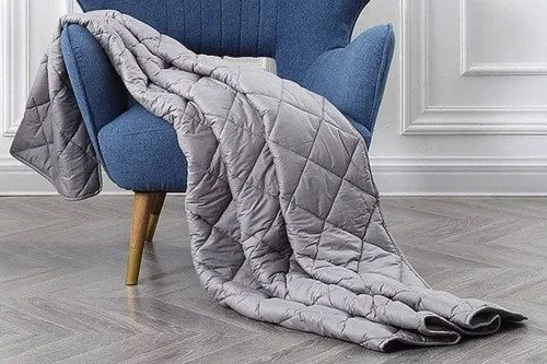 Quilted blanket draped over a chair