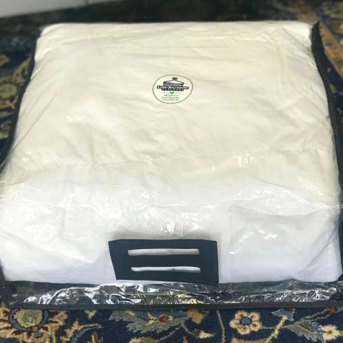 Cleaned comforter folded in clear plastic case