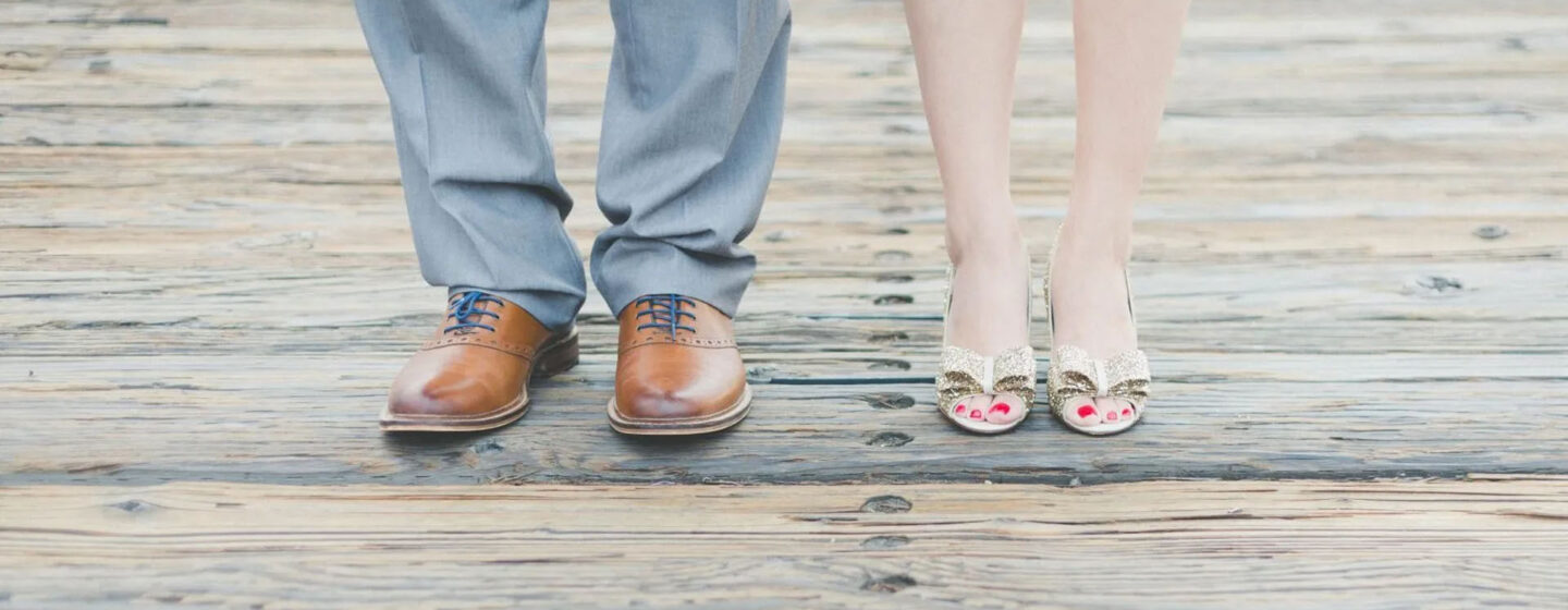 Shoes - photo of a man and woman from knees to shoes